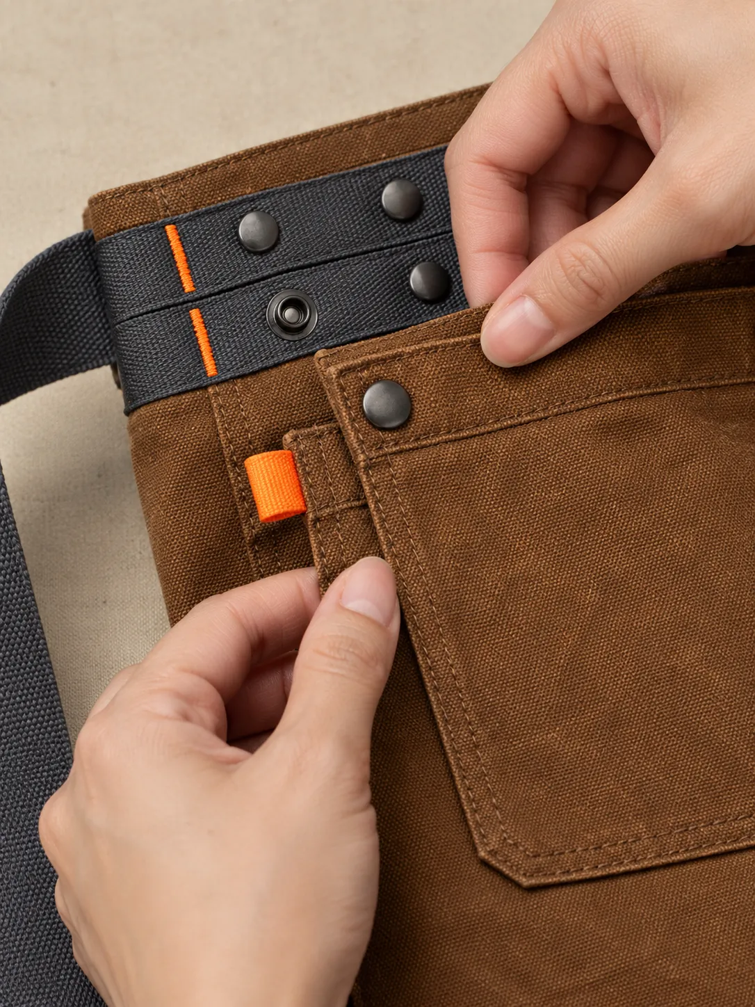 Workbench Waist Apron, close-up of the snap rail and pull tab